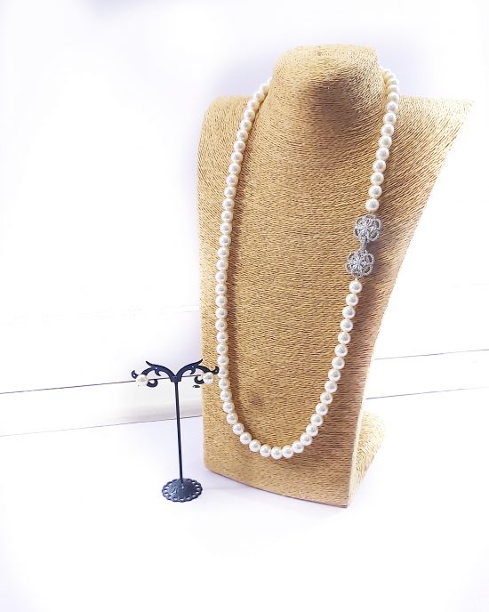 Single strand shell pearl bead with zirconia silver clasps.